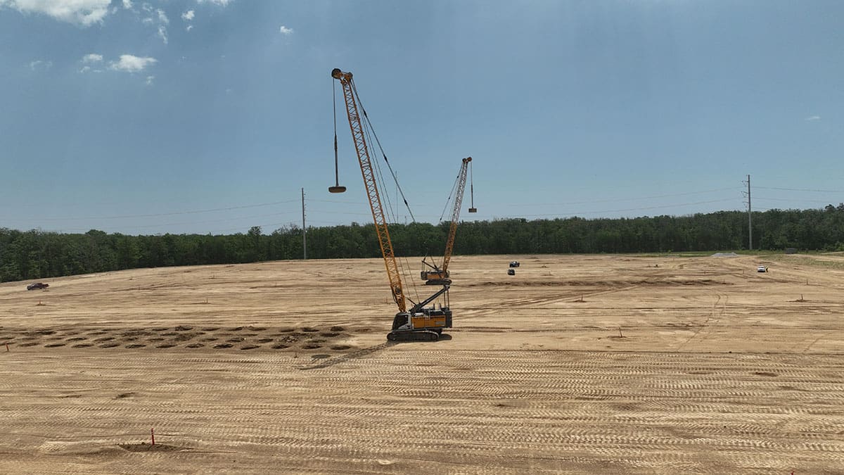 DYNAMIC-COMPACTION Heavy machinery performing dynamic compaction on a construction site to improve soil stability